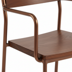 Close-up detail of bronze metal dining chair with wooden seat showing quality craftsmanship